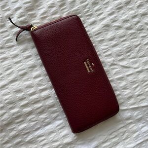 Oxblood Red Leather Kate Spade Zip Up Wallet with Striped Lining & Gold Accents